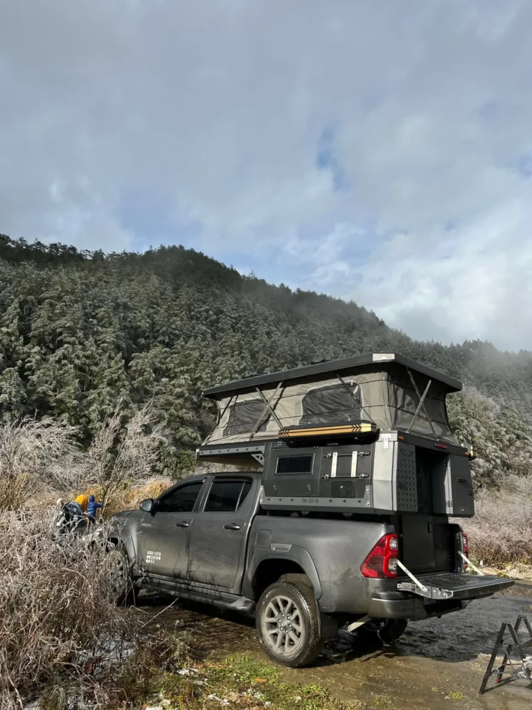 side profile of expedition truck in winter landscape
