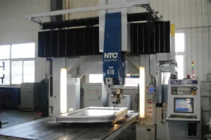 A massive hydraulic stamping press machine used to form seamless metal body panels for slide-in truck campers in the factory.