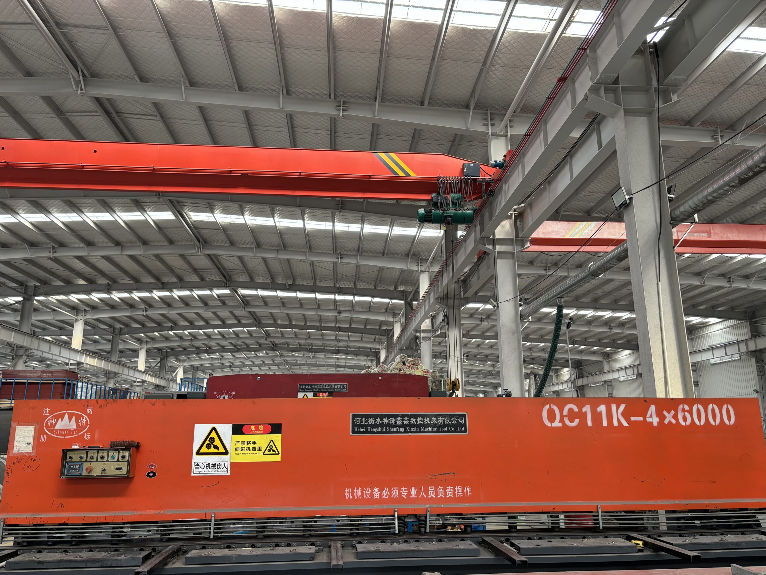 Interior view of the camper assembly line featuring heavy-duty overhead cranes and automated machinery.