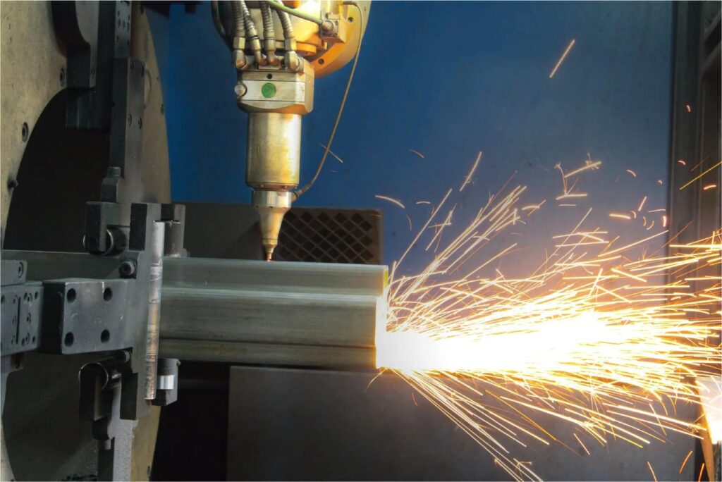 Close-up of high-precision welding sparks flying during the fabrication of a steel truck camper frame, showcasing manufacturing detail.