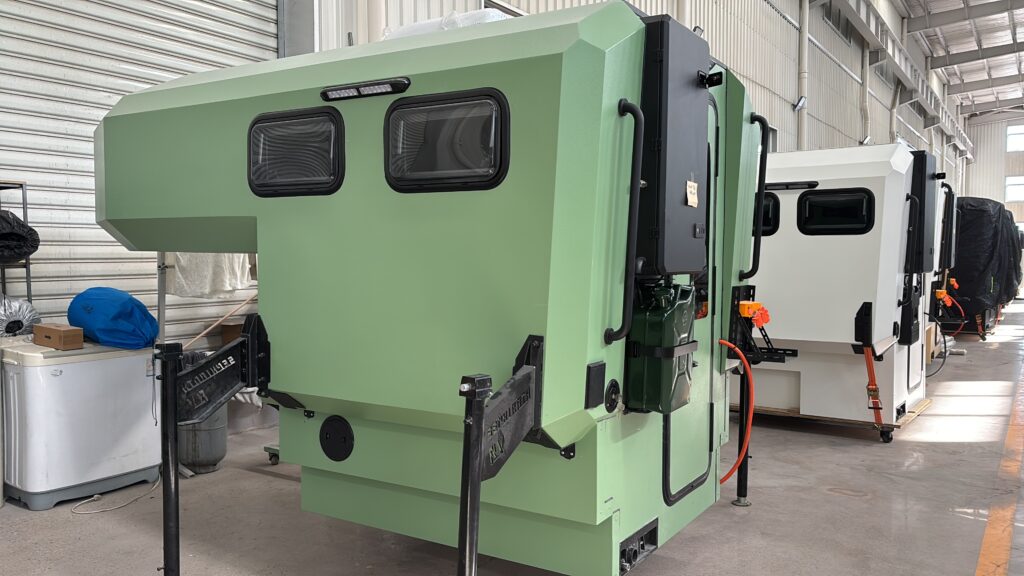 A bulk shipment of KROZADO ALPINE hard top truck campers ready for B2B wholesale distribution at a German dealership.